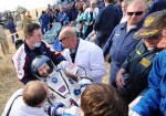 Burbank being carried to the medical tent after being extracted from the Soyuz (Credits: Kirill Kudryavtsev / AFP - Getty Images).