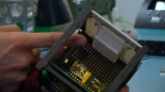 Shea demonstrates the Microthrust prototype mounted in a standard 1U Cubesat frame (Credits: EPFL News).