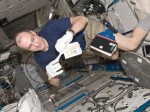 Astronaut Don Pettit, who returned from 6 months aboard ISS on July 1, prepares a biological sample for the freezer (Credits: NASA).