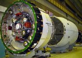 In the foreground, the Breeze-M stage is comprised of a central propellant tank together with the main propulsion system and an auxiliary donut-shaped propellant tank (Credits: Khrunichev).