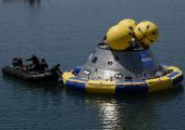Rescue divers secure a flotation ring around a mockup of NASA's new Orion spacecraft during water splashdown tests in Florida in 2009 (Credits: NASA/Dmitri Gerondidakis).