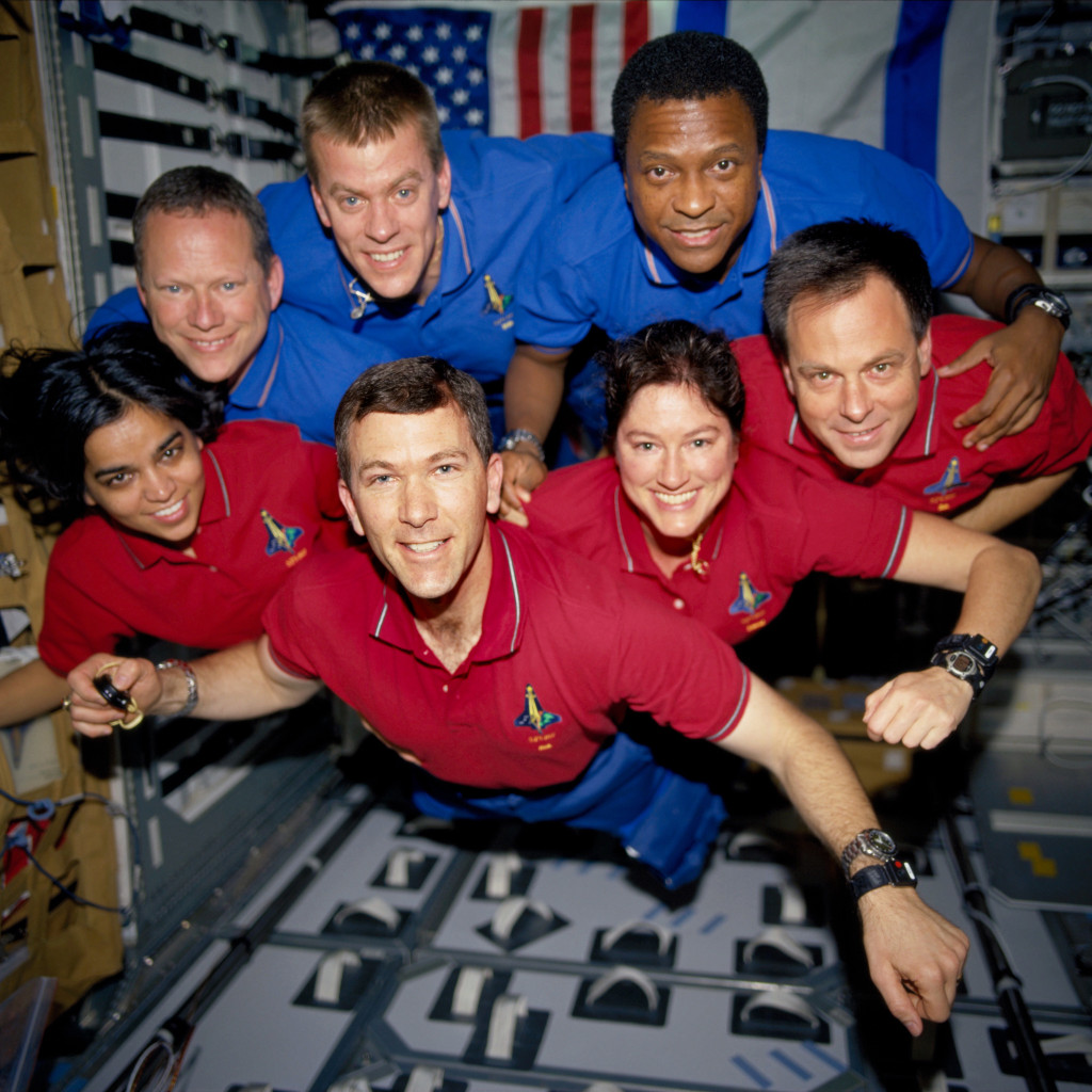 This photograph was taken aboard Columbia during STS-107; it was developed after the crew’s death from film recovered in the wreckage. From top left: David M. Brown, William C. McCool, and Michael P. Anderson. From bottom left: Kalpana Chawla, Rick D. Husband, Laurel B. Clark, and Ilan Ramon. – Credits: NASA