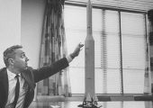 Dyer Brainerd Holmes showing a mock model of the Saturn V. His work was critical for the Apollo program