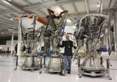 Tom Muelle rwith his Merlin engines as SpaceX headquarters (Credits: Roger Gilbertson/Tom Mueller).
