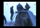 Ground crew clamber over the Soyuz 06M capsule after Expeditio n34 lands (Credits: NASA).