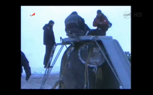 Ground crew clamber over the Soyuz 06M capsule after Expeditio n34 lands (Credits: NASA).