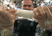 ISS Commander Chris Hadfield wrings a washcloth on ISS
