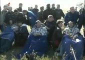 Expedition 35 crew, seated, catch their breath after landing. From left: Chris Hadfield, Roman Romanenko, and Tom Marshburn (Credits: Roscosmos/NASA).