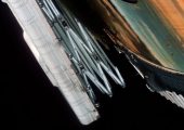 Clogged with debris, Skylab’s sole surviving solar array was left pinned to the side of the station. This view from the first crew illustrates the daunting nature of the problem (Credits: NASA).