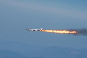 SpaceShipTwo firing its hybrid rocket engine (Credits: Virgin Galactic).