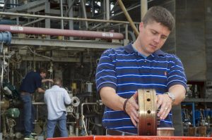 An engineer inspects the injector (Credits: NASA).