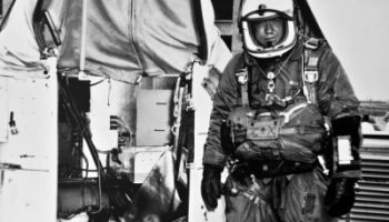 Then-Capt. Joseph Kittinger stands next to the Excelsior gondola which, supported by a helium balloon, carried him 102,800 feet above Earth. Kittinger set historical records for highest balloon ascent, highest parachute jump, longest drogue fall and fastest speed by a human being through the atmosphere. The 52-year-old records stood until last fall when an effort aided by Kittinger himself broke his records (Credits: U.S. Air Force photo).