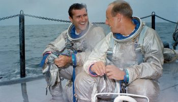 Dick Gordon (left) and Pete Conrad await the start of an emergency water egress training exercise in the Gulf of Mexico in July 1966 (Credits: NASA).