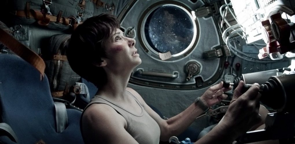 Gravity's Dr. Ryan Stone (Sandra Bullock) takes respite in a Soyuz (Credits: Warner Bros.).