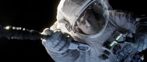 "Gravity" astornaut Matt Kowalski (George Clooney) reaches to secure his tether during EVA (Credits: Warner Bros.).