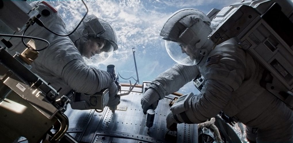 "Gravity" astronauts Ryan Stone (Sandra Bullock) and Matt Kowalski (George Clooney) repair the Hubble Space Telescope (Credits: Warner Bros.).