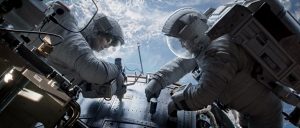 "Gravity" astronauts Ryan Stone (Sandra Bullock) and Matt Kowalski (George Clooney) repair the Hubble Space Telescope (Credits: Warner Bros.).