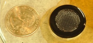 Ferrofluid in action: A puddle of ferrofluid sitting on a small, permanent magnet. Ferrofluids are made with tiny magnetic particles that form uncanny shapes that seem to defy gravity when interacting with a magnet (Credits: Sarah Bird).