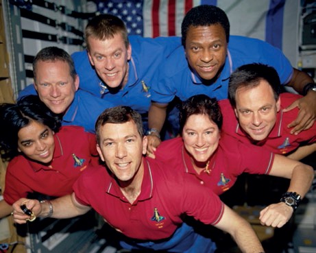 This photograph was taken aboard Columbia during STS-107; it was developed after the crew’s death from film recovered in the wreckage. From top left: David M. Brown, William C. McCool, and Michael P. Anderson. From bottom left: Kalpana Chawla, Rick D. Husband, Laurel B. Clark, and Ilan Ramon (Credits: NASA).