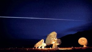 Space Shuttle Columbia streaking over the Very Large Array radio telescope in  Socorro, New Mexico