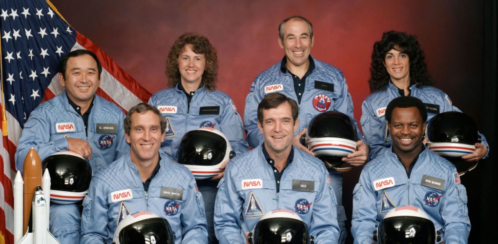 The crew of Space Shuttle mission STS-51-L. In the back row from left to right: Ellison S. Onizuka, Sharon Christa McAuliffe, Greg Jarvis, and Judy Resnik. In the front row from left to right: Michael J. Smith, Dick Scobee, and Ron McNair. Credits: NASA