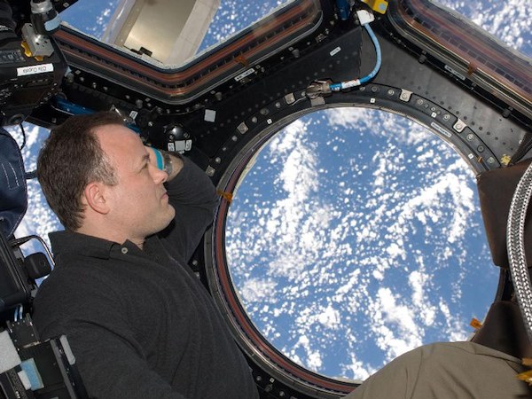 NASA astronaut Ron Garan gazes at Earth from the International Space Station. Research indicates long-duration spaceflights may negatively impact eyesight. (Credits: NASA).