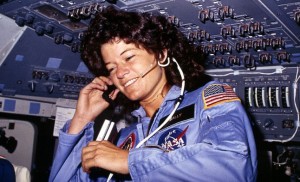 This NASA file photo, dated June 1983, shows America's first woman astronaut Sally Ride as she communicates with ground controllers from the flight deck during the six-day space mission of the Challenger (Credits: NASA/Getty Images).
