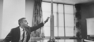 Dyer Brainerd Holmes showing a mock model of the Saturn V. His work was critical for the Apollo program
