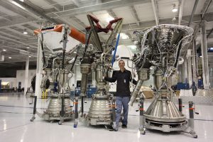 Tom Muelle rwith his Merlin engines as SpaceX headquarters (Credits: Roger Gilbertson/Tom Mueller).