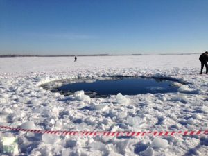 The hole in Lake Chebarkul formed by a meteorite fragment (Credits: Andrey Orlov/RT).