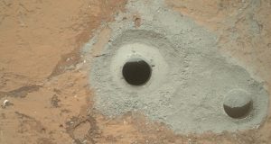 The bore-hole at John Klein, showing the lesser oxidized grey powder (Credits: NASA.)