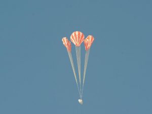 Engineers rigged one of the test capsule’s three main parachutes – the middle parachute in this view – to skip one stage of its inflation (Credits: NASA).