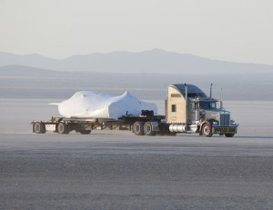 SNC's Dream Chaser test flight craft is hauled across the bed of Rogers Dry Lake at Edwards Air Force Base, Calif., to NASA's Dryden Flight Research Center on May 15. Image credit: NASA/Tom Tschida