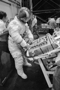 As the first crew prepared for its own repairs, the astronauts of Skylab’s second crew were getting ready for their own mission. Here Jack Lousma practices the installation of a “six-pack” of control gyroscopes (Credits: NASA).