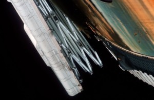 Clogged with debris, Skylab’s sole surviving solar array was left pinned to the side of the station. This view from the first crew illustrates the daunting nature of the problem (Credits: NASA).