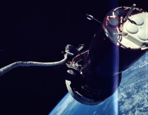 A view of Gemini IX-A, including its maneuvering thrusters, taken by Gene Cernan. His lengthy tether is clearly visible (Credits: NASA).