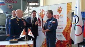 Former cosmonaut Alexey Leonov, left, the first man to perform a spacewalk, passed an Olympic Torch to Mikhail Tyurin, flight engineer of Expedition 38/39 (Credits: Dmitry Chernyshenko).