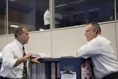 Flight Director David Korth (left) chats with fellow flight director Norm Knight during EVA-23 (Credits: NASA).