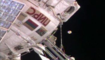 No, that object hovering just off ISS is not alien in origin: it is an antenna cover broken off the Zvezda module (Credits: NASA).