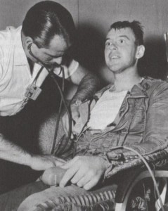A doctor examines Lt. Clifton “Demi” McClure after his Man High III mission. His parents nicknamed him Demi after he was born on the night Franklin D. Roosevelt, a Democrat, was first elected president (Credits: USAF).