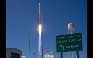 Cygnus launches behind the ISS "onramp" road sign at Wallops Island (Credits: NASA).