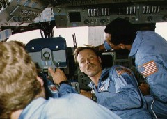 61C crewmen Steve Hawley, Robert “Hoot” Gibson (facing camera), and Charlie Bolden demonstrate the cramped nature of Columbia’s flight deck during the mission (Credits: NASA).