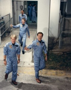 Robert “Hoot” Gibson (right) and George “Pinky” Nelson lead the 61C crew out of the Operations & Checkout Building for launch. Following is crewmate Steve Hawley (Credits: NASA).