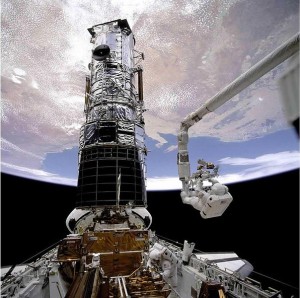 Musgrave is anchored on the end of the Remote Manipulator System arm during STS-61, Hubble's first servicing mission (Credits: NASA). 