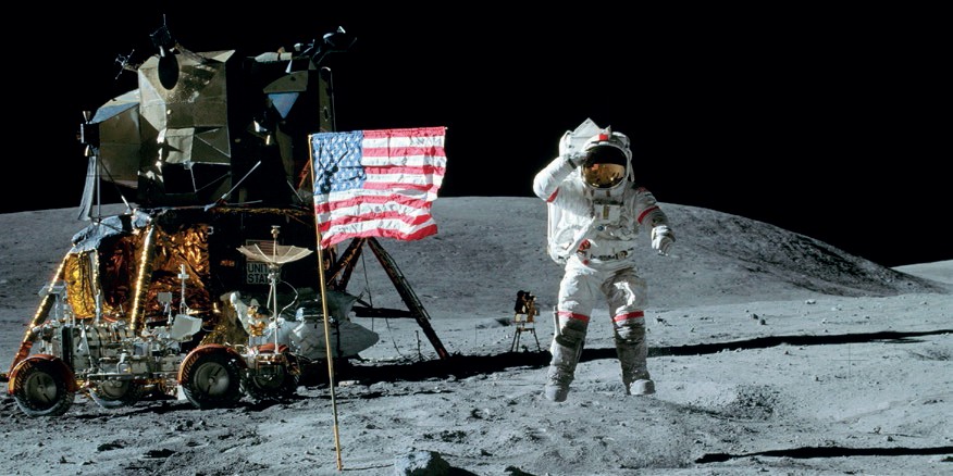 John Young (pictured here while saluting the flag on Apollo 16’s first EVA) received the news about the approval of the Shuttle program while walking on the Moon. He would later become Commander of  the Space Shuttle inaugural flight (Credits: NASA).
