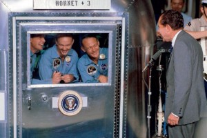 President Nixon speaks with the Apollo 11 crew,  in quarantine after their historic mission (Credits: NASA).
