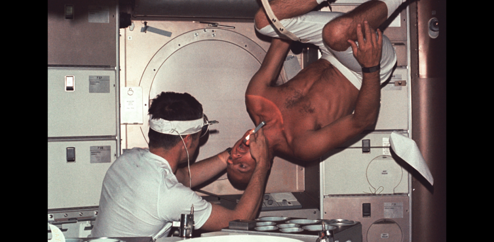 Skylab 1 commander Pete Conrad undergoes a dental examination by medical officer Joseph Kerwin