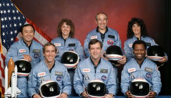 The crew of Space Shuttle mission STS-51-L. In the back row from left to right: Ellison S. Onizuka, Sharon Christa McAuliffe, Greg Jarvis, and Judy Resnik. In the front row from left to right: Michael J. Smith, Dick Scobee, and Ron McNair. Credits: NASA