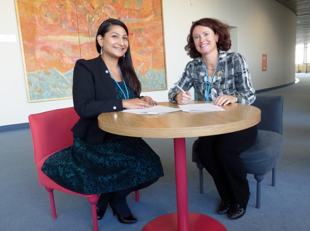 SGAC Executive Director Minoo Rathnasabapathy (left) and IAASS President Isabelle Rongier (right) sign the MoU.