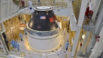NASA’s first completed Orion crew module sits atop its service module at the Neil Armstrong Operations and Checkout Facility at Kennedy Space Center in Florida. credits: NASA